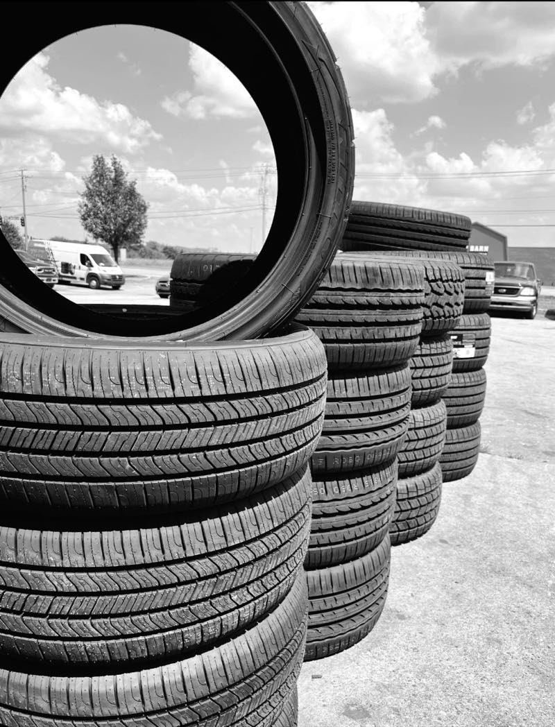 Stacks of new and used tires in the lot at Affordable Tire Co in Knoxville